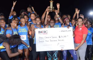 Hydel High Track & Field team being presented with a trophy and symbolic cheque by Lori- Ann Glasgow- GM, Marketing (BCIC).